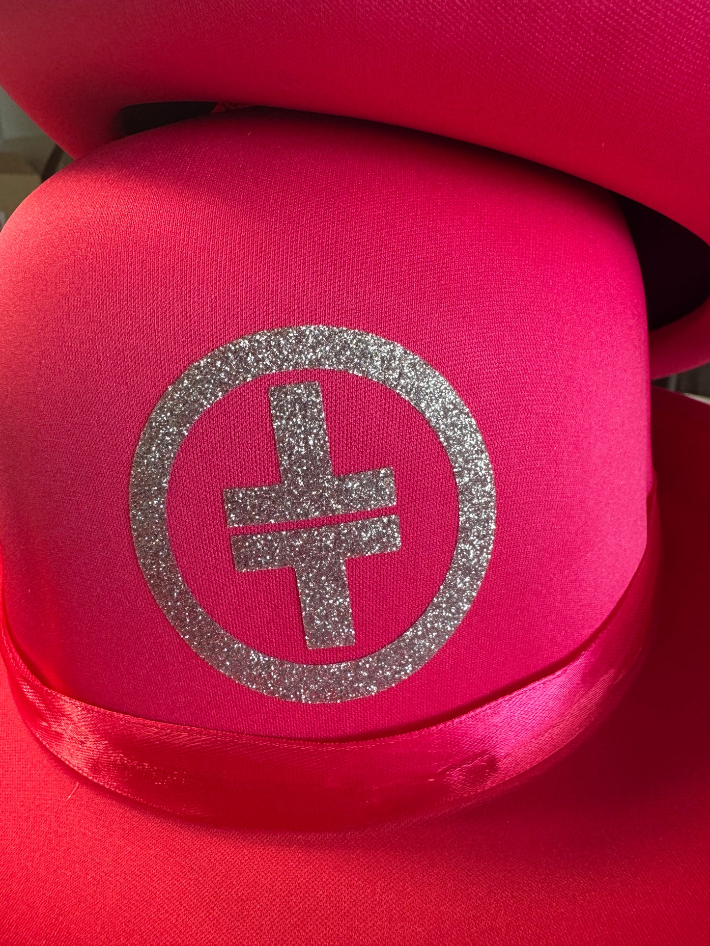 Pink bowler hat with silver glitter logo